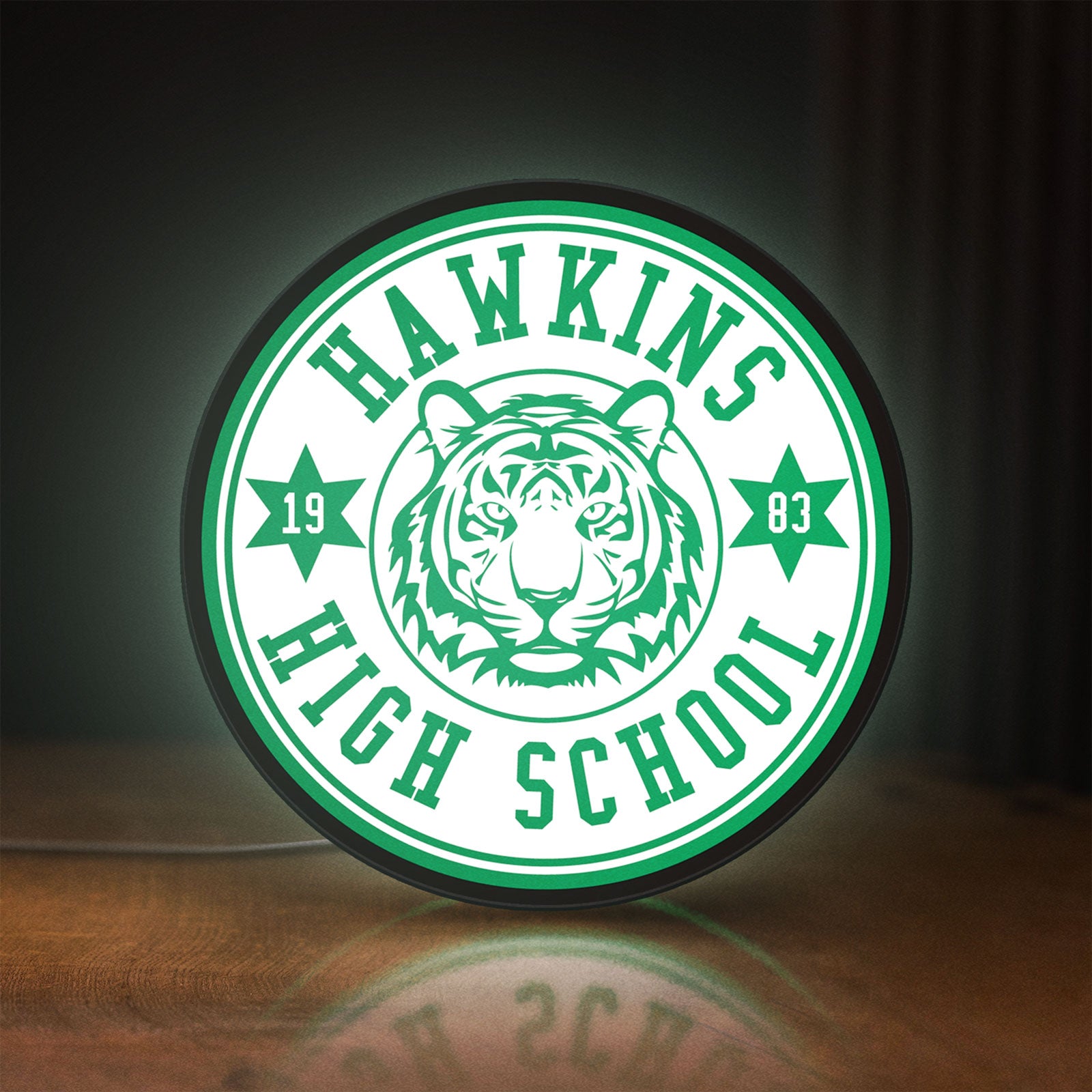 Front view of Hawkins Stranger Things LED lightbox sign glowing on a wooden desk