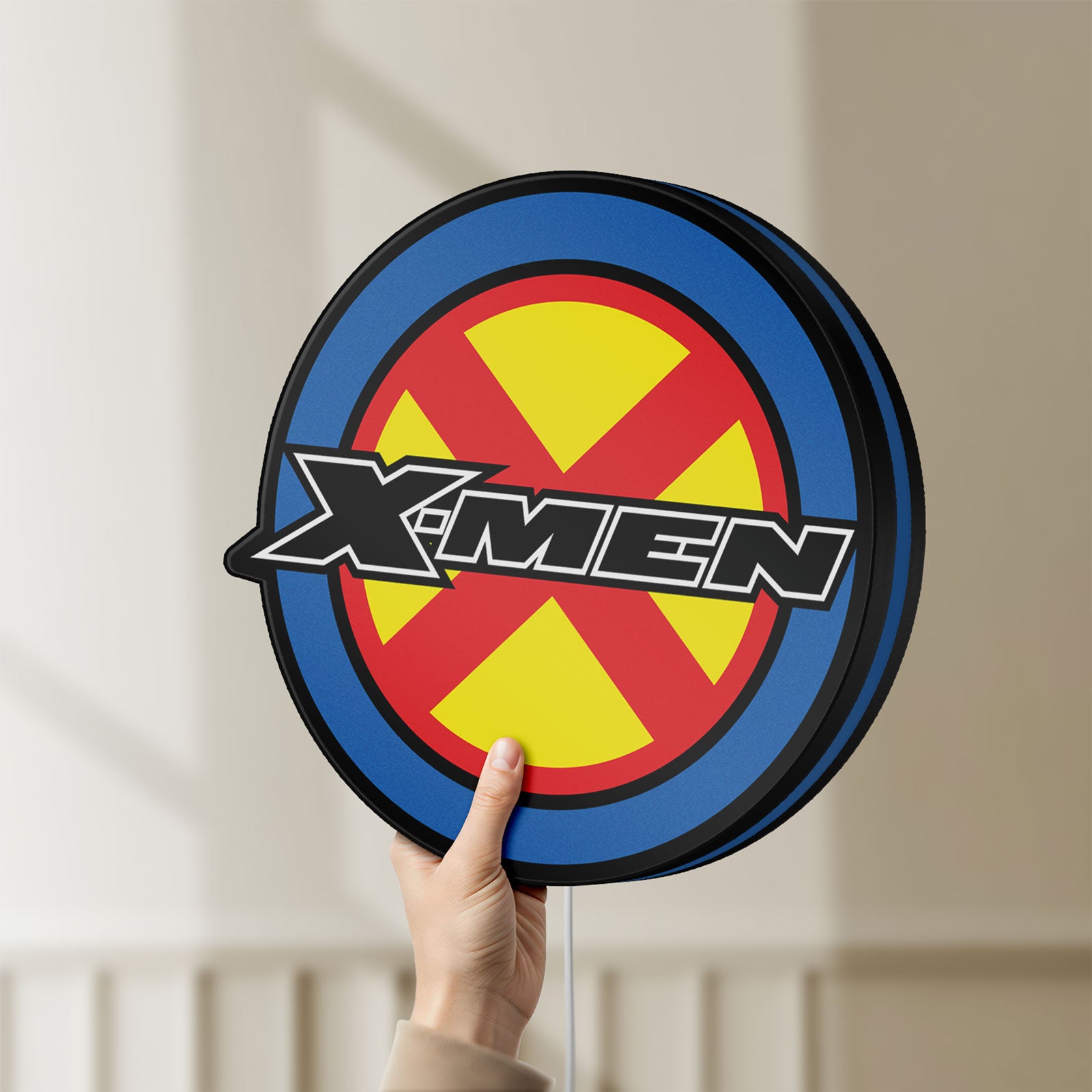 Unlit X-Men LED lightbox held by hand to show size and details