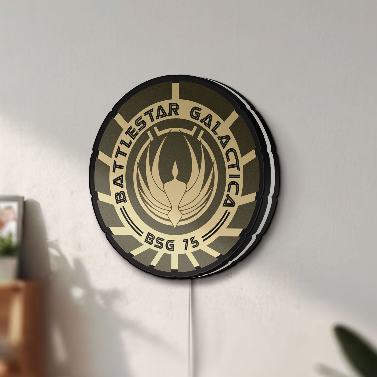 Unlit Battlestar Galactica Colonial Emblem LED lightbox mounted on a wall in daylight