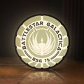 Front view of Battlestar Galactica Colonial Emblem LED lightbox sign glowing on a wooden desk
