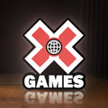 Front view of X-Games LED lightbox sign glowing on a wooden desk