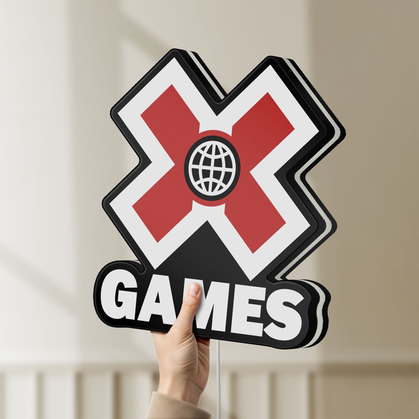 Unlit X-Games LED lightbox held by hand to show size and details