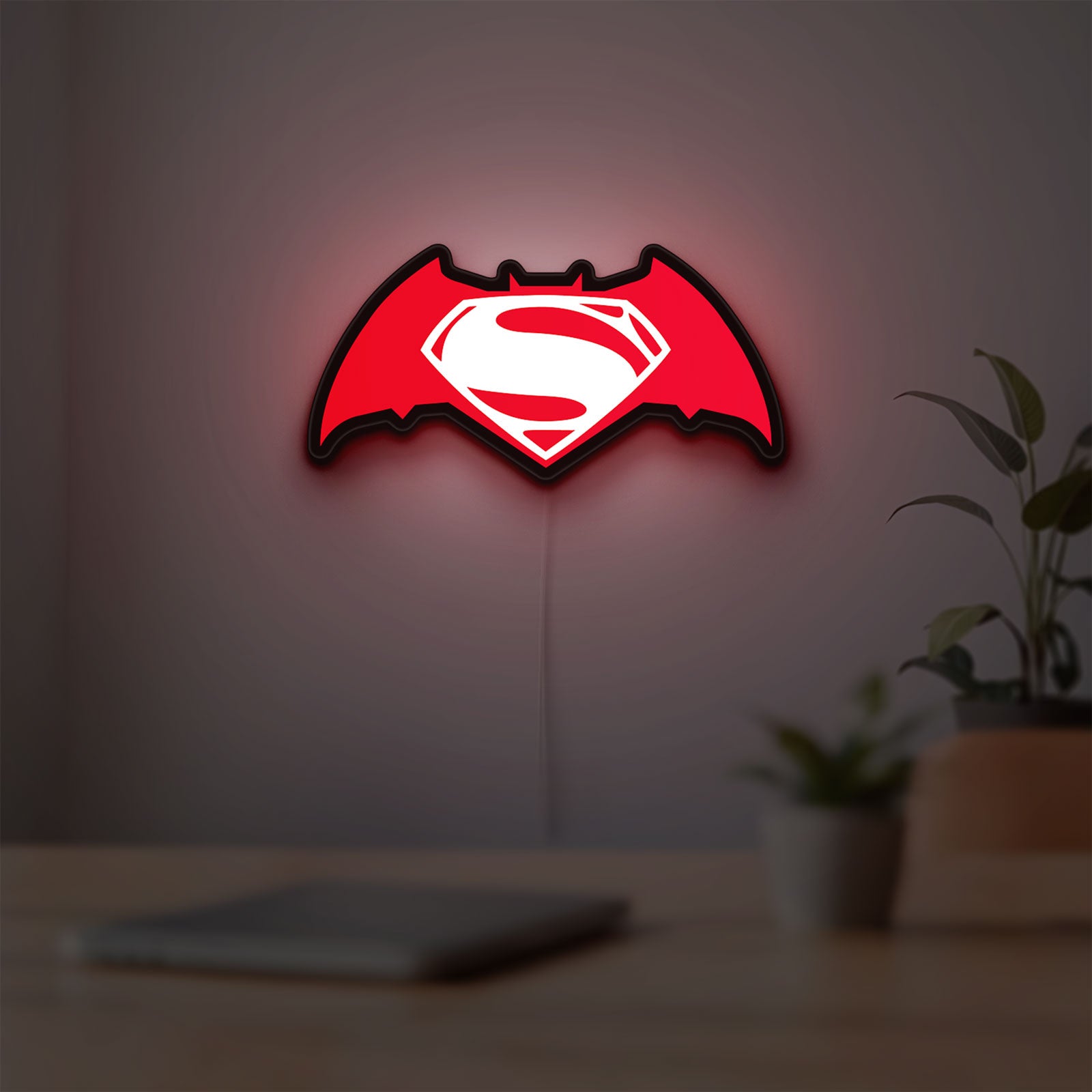Batman v Superman LED lightbox hanging on a room wall with soft red light