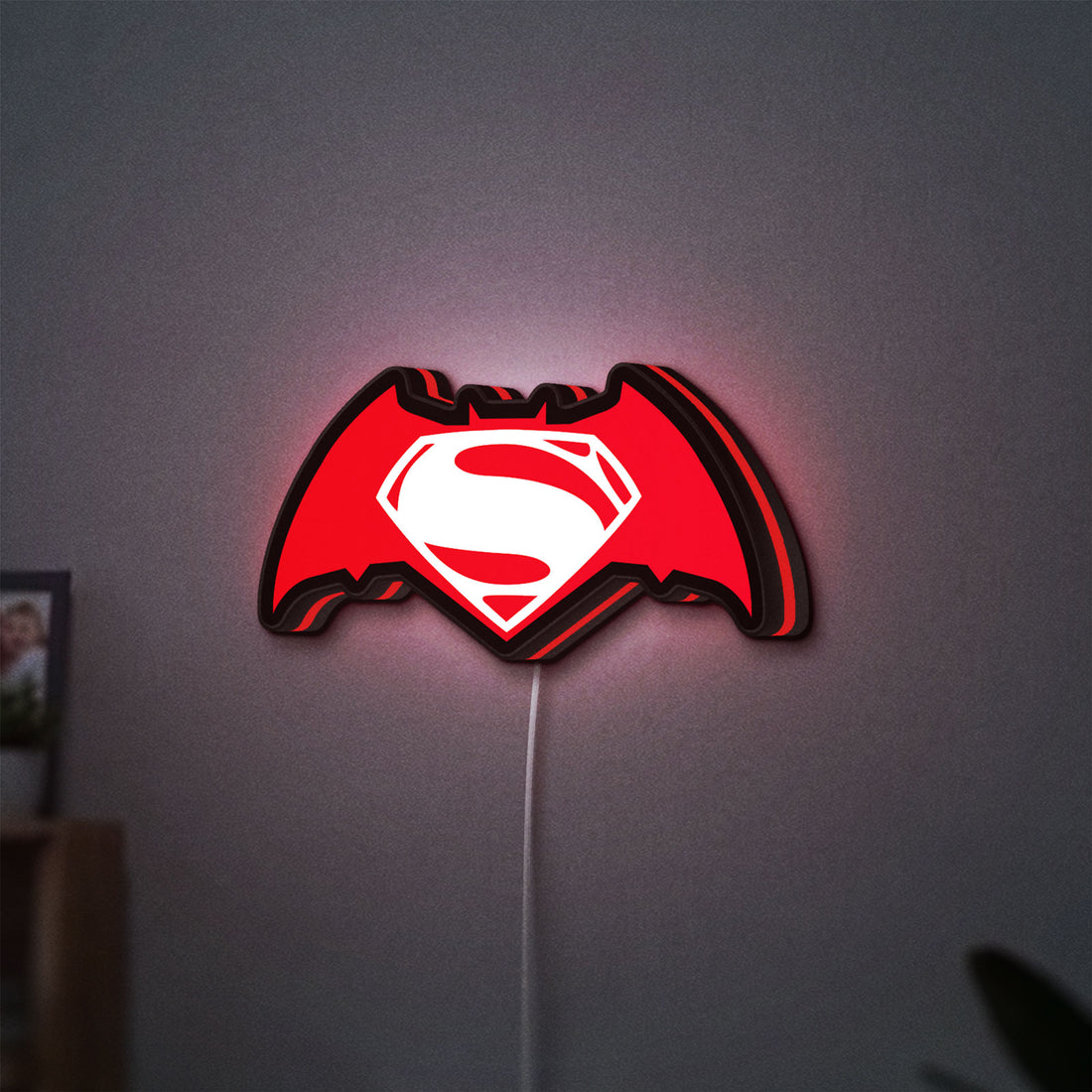 Batman v Superman LED lightbox hanging on a wall with red glow