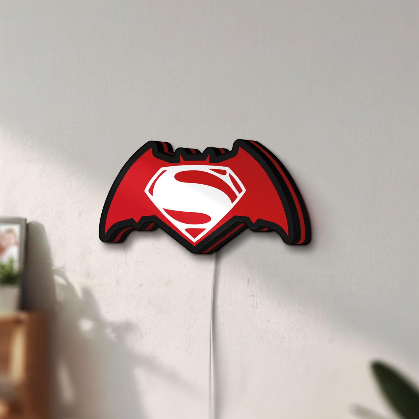 Unlit Batman v Superman LED lightbox mounted on a wall in daylight