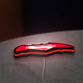 Batman v Superman LED lightbox lying flat on a desk with red glow