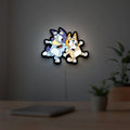 Bluey LED lightbox hanging on a room wall with soft white light