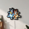 Unlit Bluey LED lightbox mounted on a wall in daylight