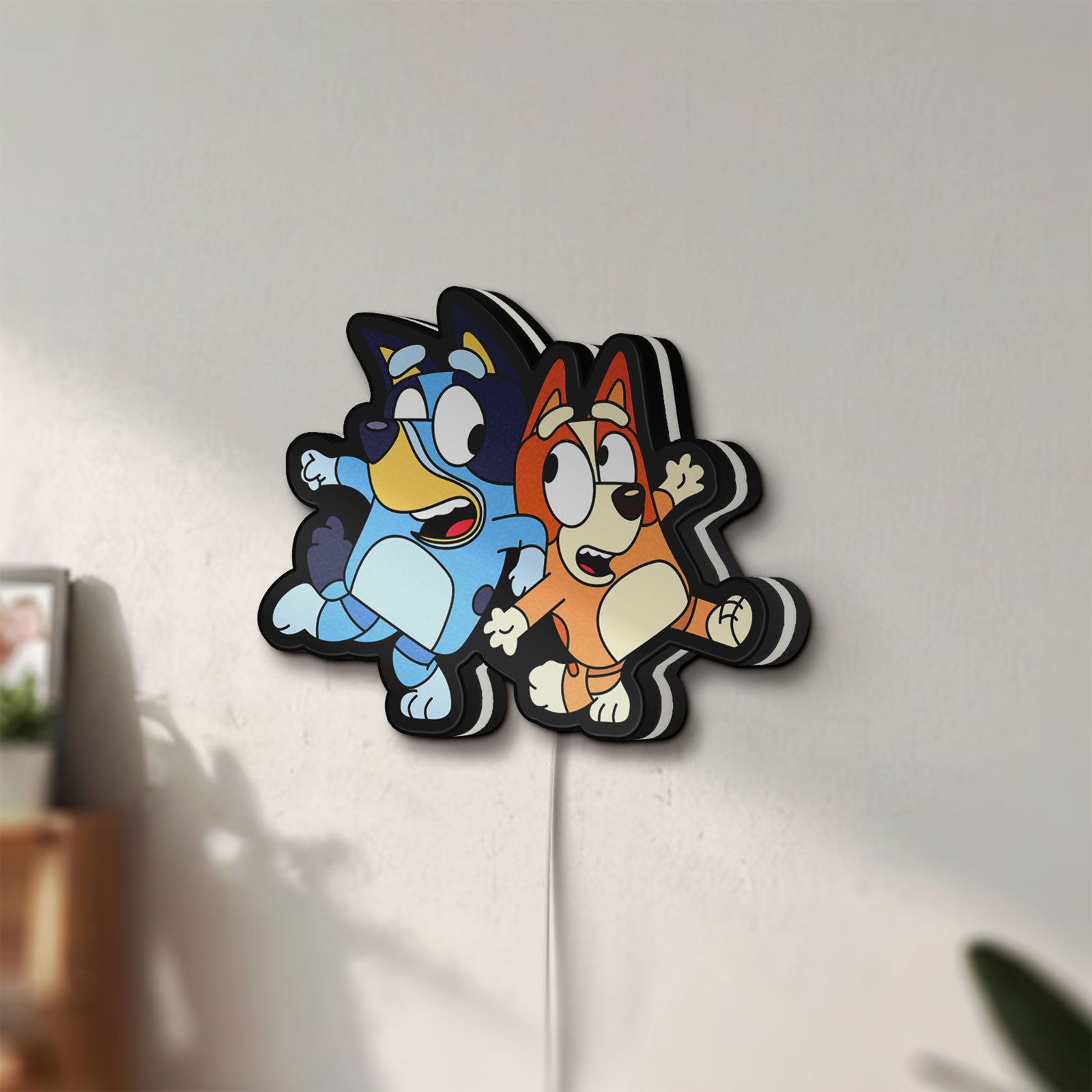 Unlit Bluey LED lightbox mounted on a wall in daylight