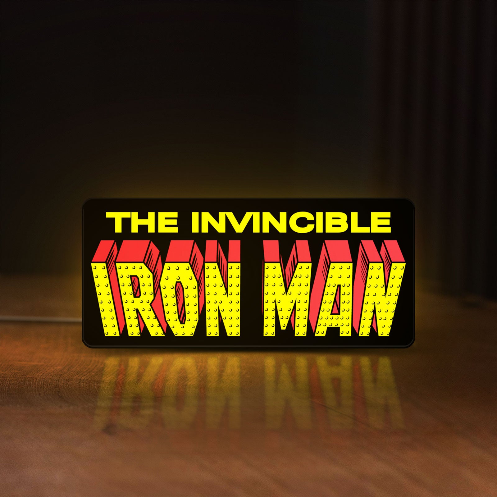 Front view of Iron Man Comic Style LED lightbox sign glowing on a wooden desk