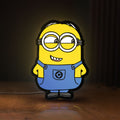 Front view of Minions Character LED lightbox sign glowing on a wooden desk