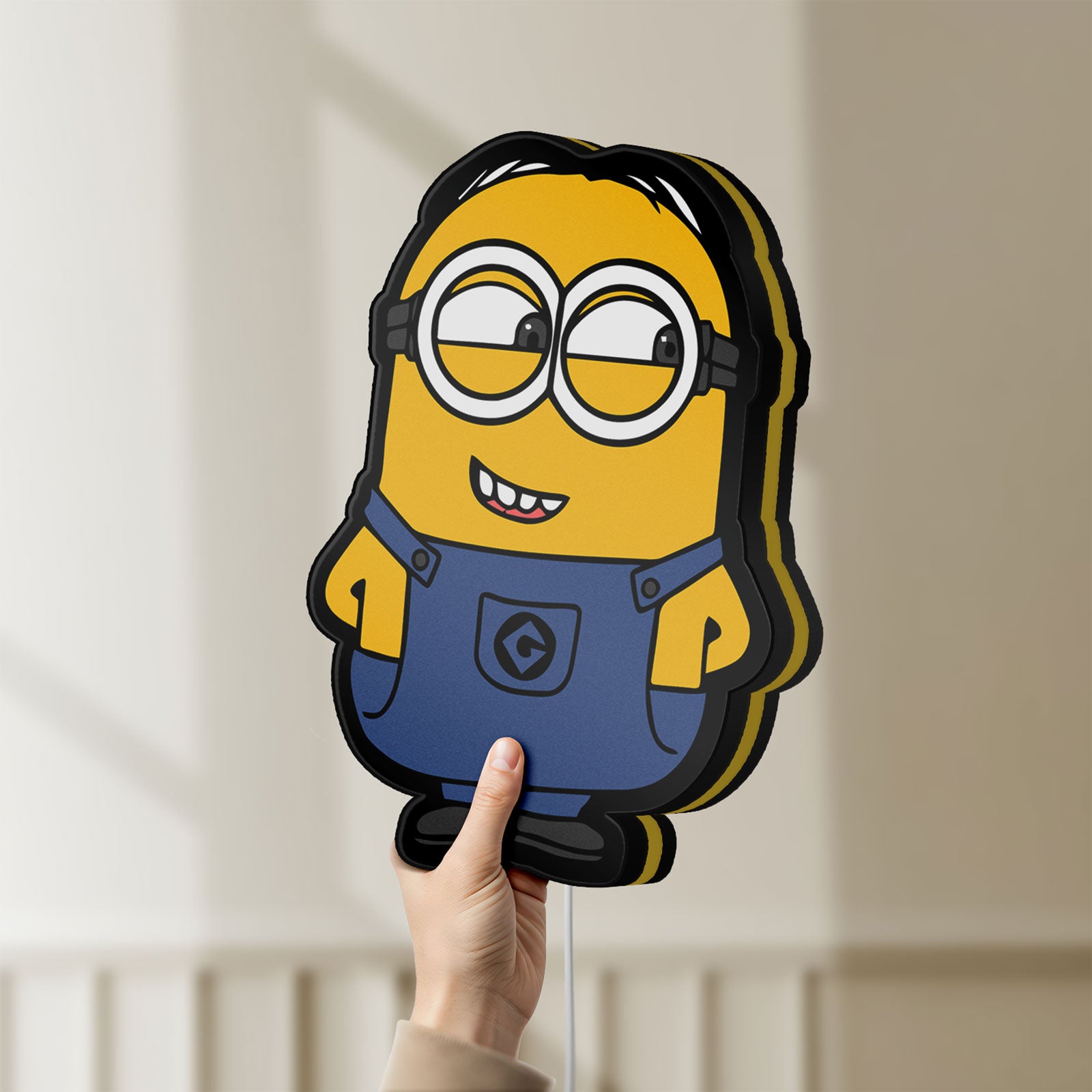 Unlit Minions Character LED lightbox held by hand to show size and details