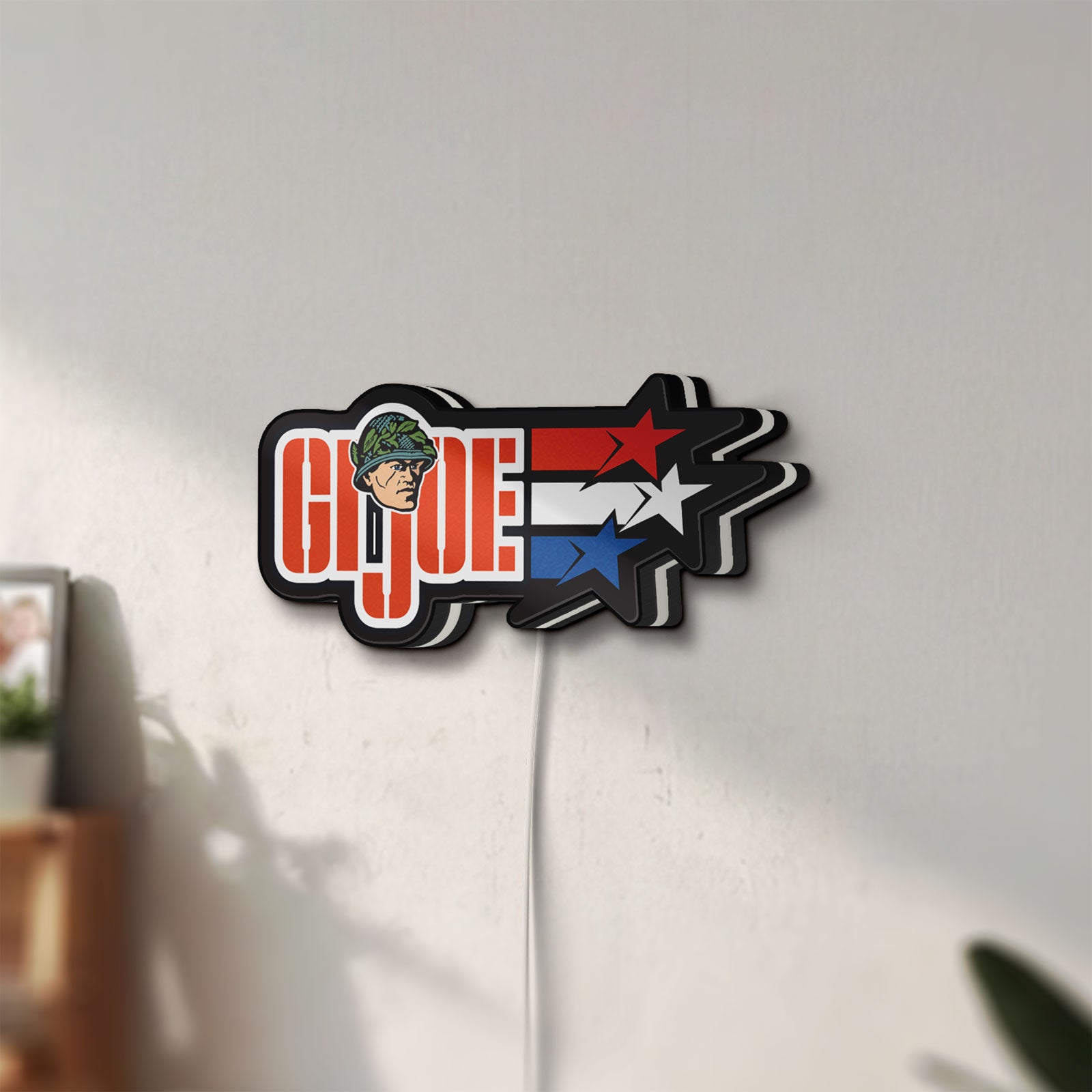 Unlit G.I. Joe LED lightbox mounted on a wall in daylight