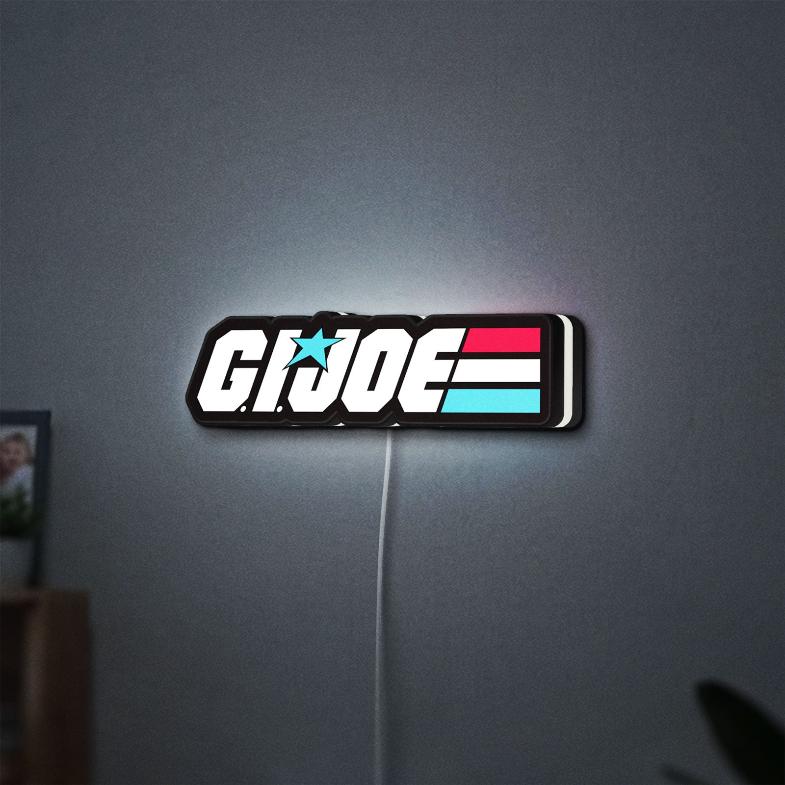 G.I. Joe LED lightbox hanging on a wall with white glow