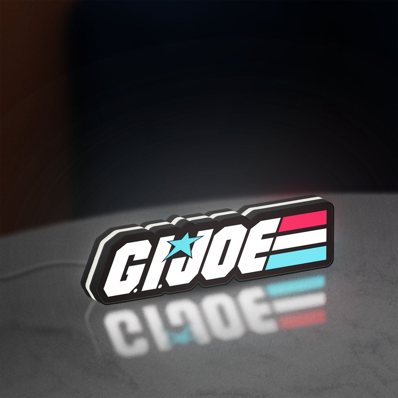 G.I. Joe LED lightbox standing on a desk from an angled side view with white glow