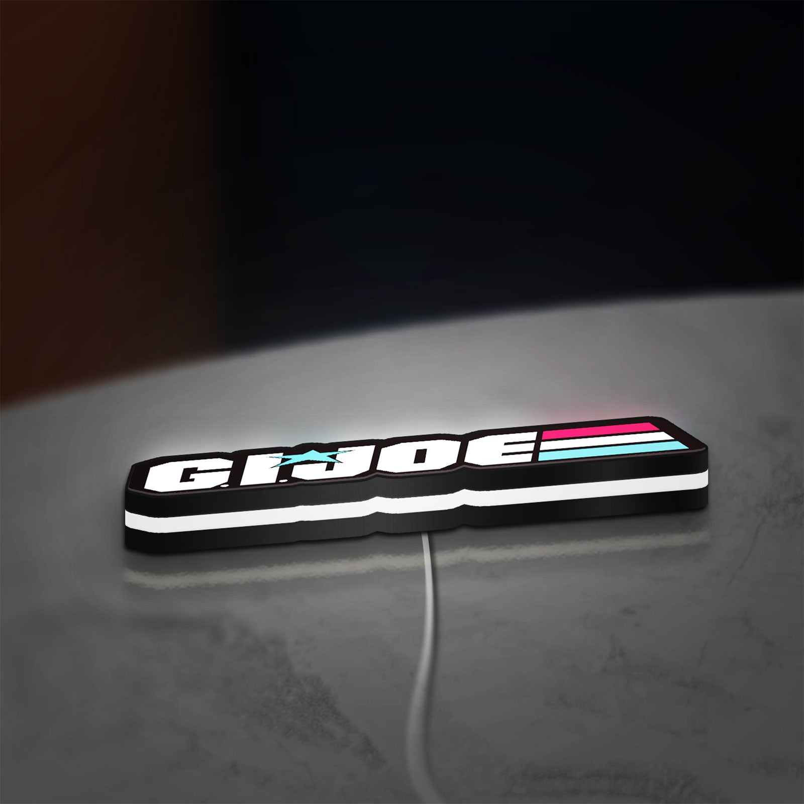 G.I. Joe LED lightbox lying flat on a desk with white glow