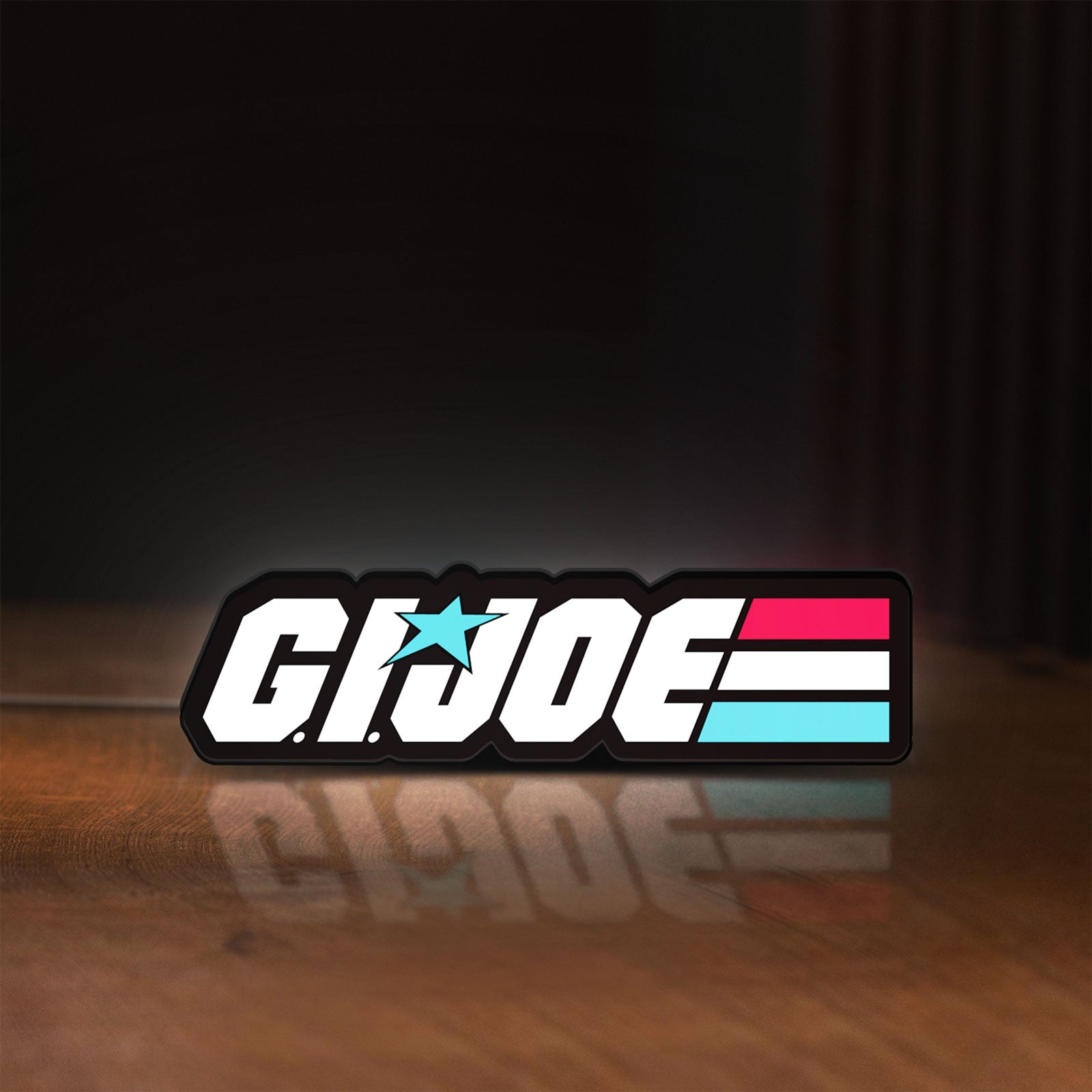 Front view of G.I. Joe LED lightbox sign glowing on a wooden desk