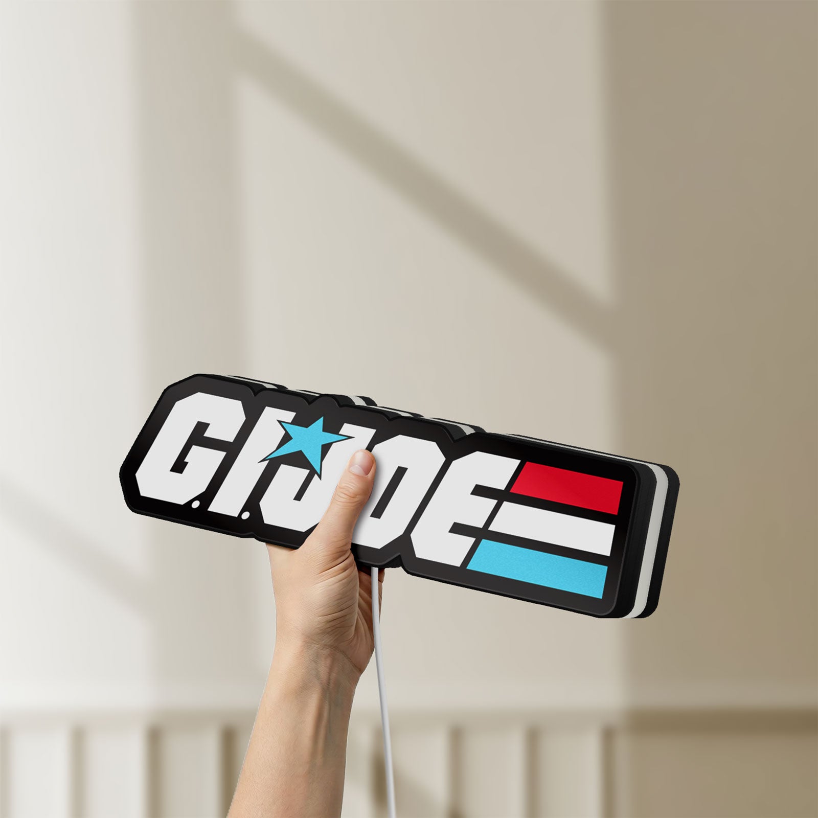 Unlit G.I. Joe LED lightbox held by hand to show size and details