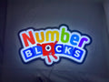 Numberblocks LED Light Box (40cm) - Illuminated flat lay front view, unique wall art for desk and room decor