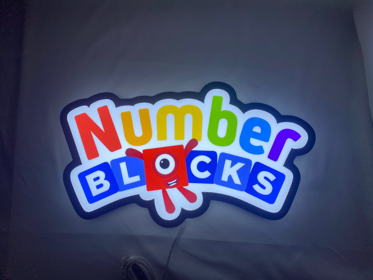 Numberblocks LED Light Box (40cm) - Illuminated flat lay front view, unique wall art for desk and room decor