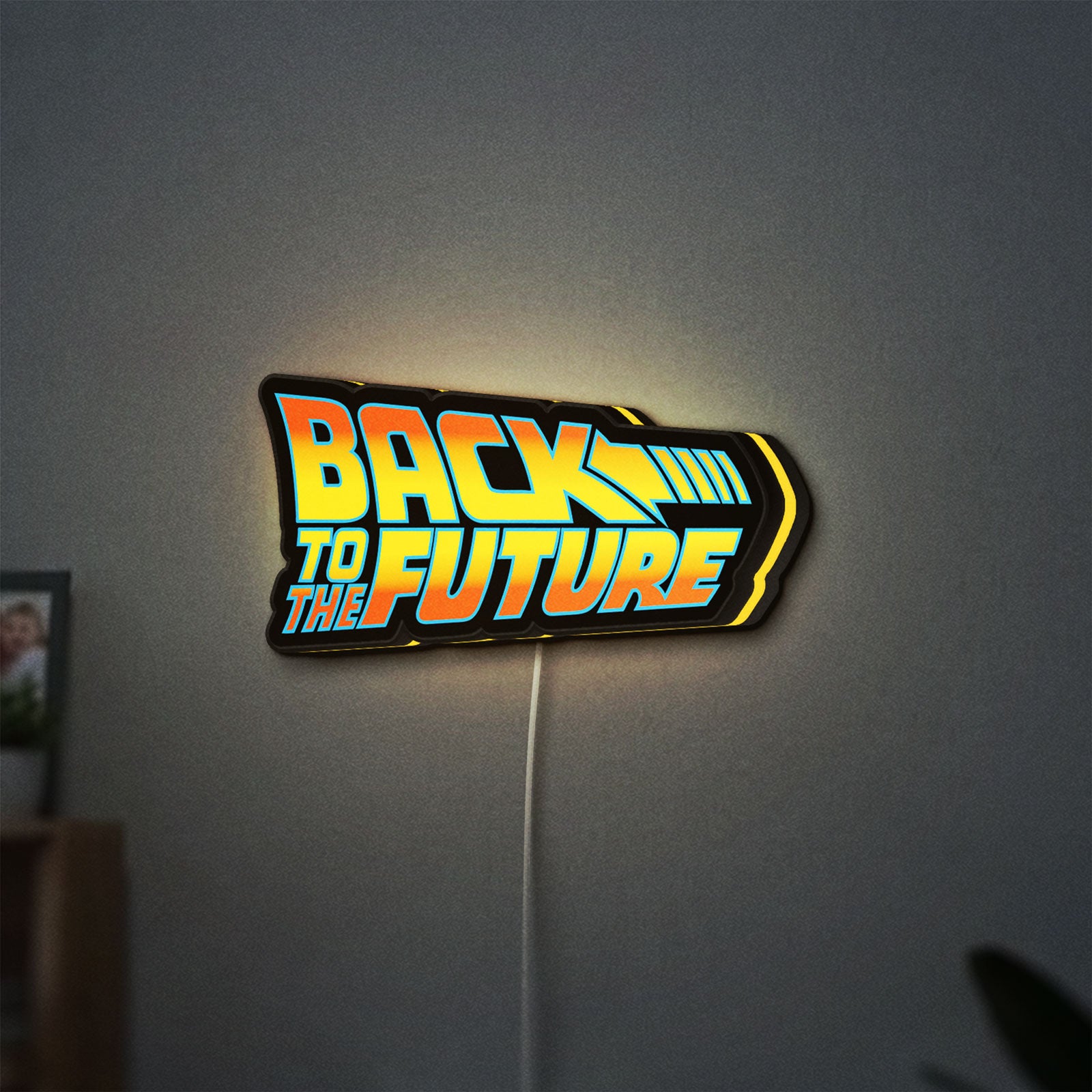 Back to the Future DeLorean LED lightbox hanging on a wall with yellow glow