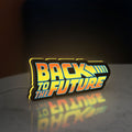 Back to the Future DeLorean LED lightbox standing on a desk from an angled side view with yellow glow