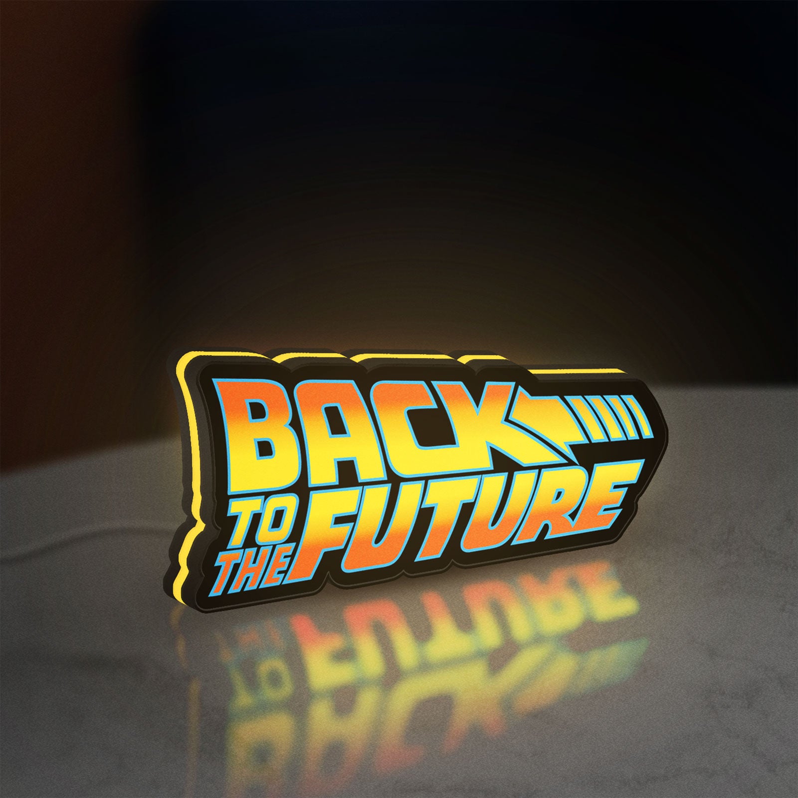 Back to the Future DeLorean LED lightbox standing on a desk from an angled side view with yellow glow