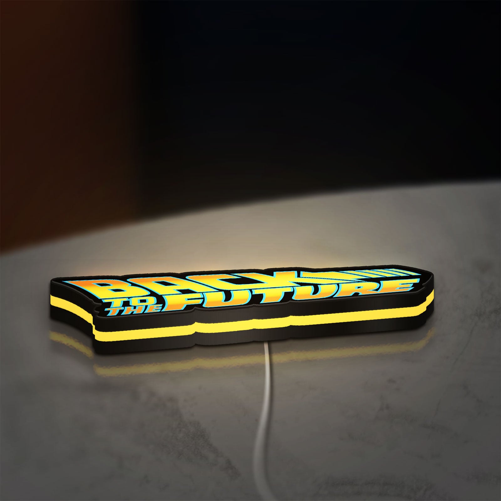 Back to the Future DeLorean LED lightbox lying flat on a desk with yellow glow