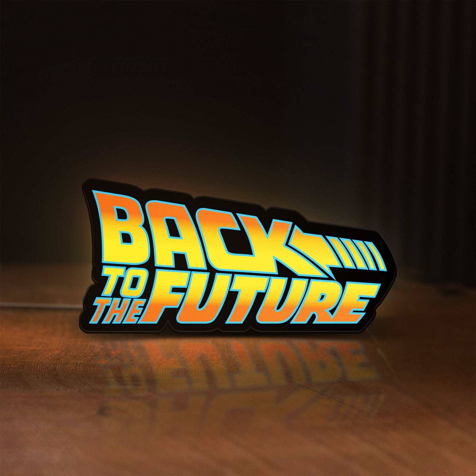 Front view of Back to the Future DeLorean LED lightbox sign glowing on a wooden desk