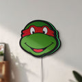 Unlit Teenage Mutant Ninja Turtles LED lightbox mounted on a wall in daylight