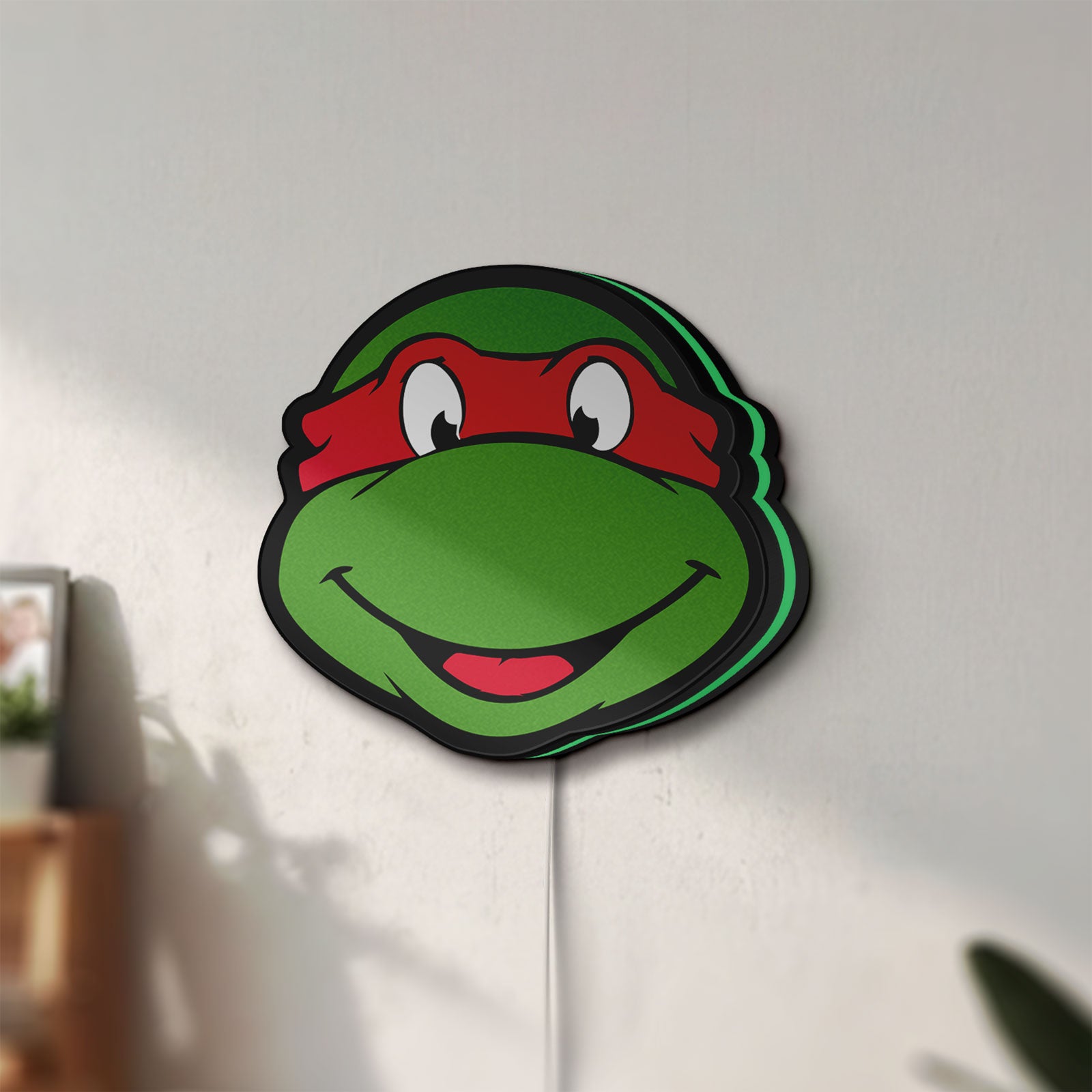 Unlit Teenage Mutant Ninja Turtles LED lightbox mounted on a wall in daylight