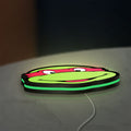 Teenage Mutant Ninja Turtles LED lightbox lying flat on a desk with green glow