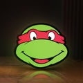 Front view of Teenage Mutant Ninja Turtles LED lightbox sign glowing on a wooden desk