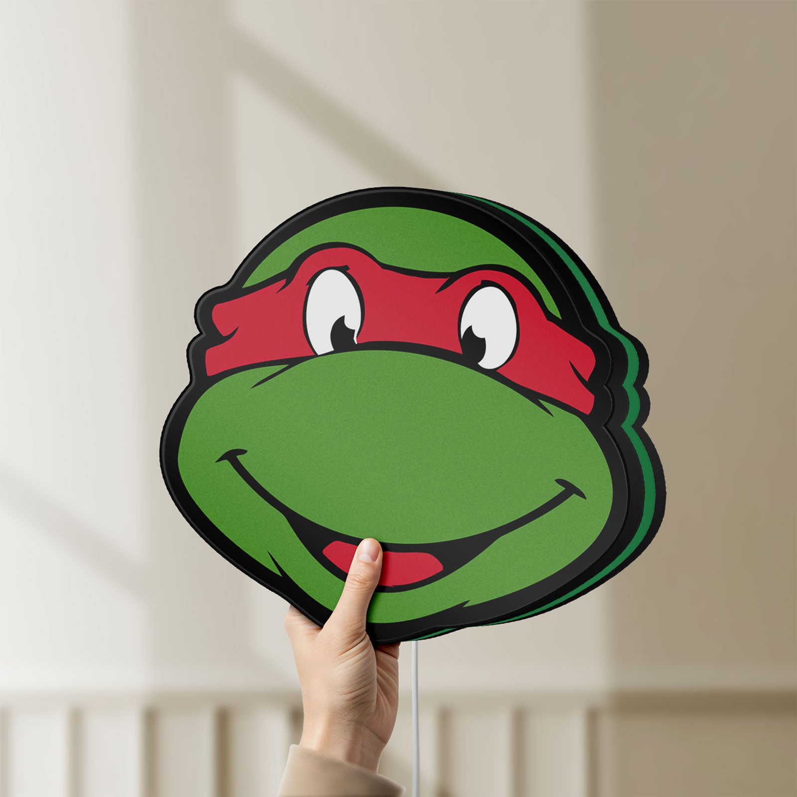Unlit Teenage Mutant Ninja Turtles LED lightbox held by hand to show size and details
