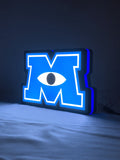 Illuminated angled view standing of Monsters University 3D LED Sign in 20cm, unique wall art for desk and room decor