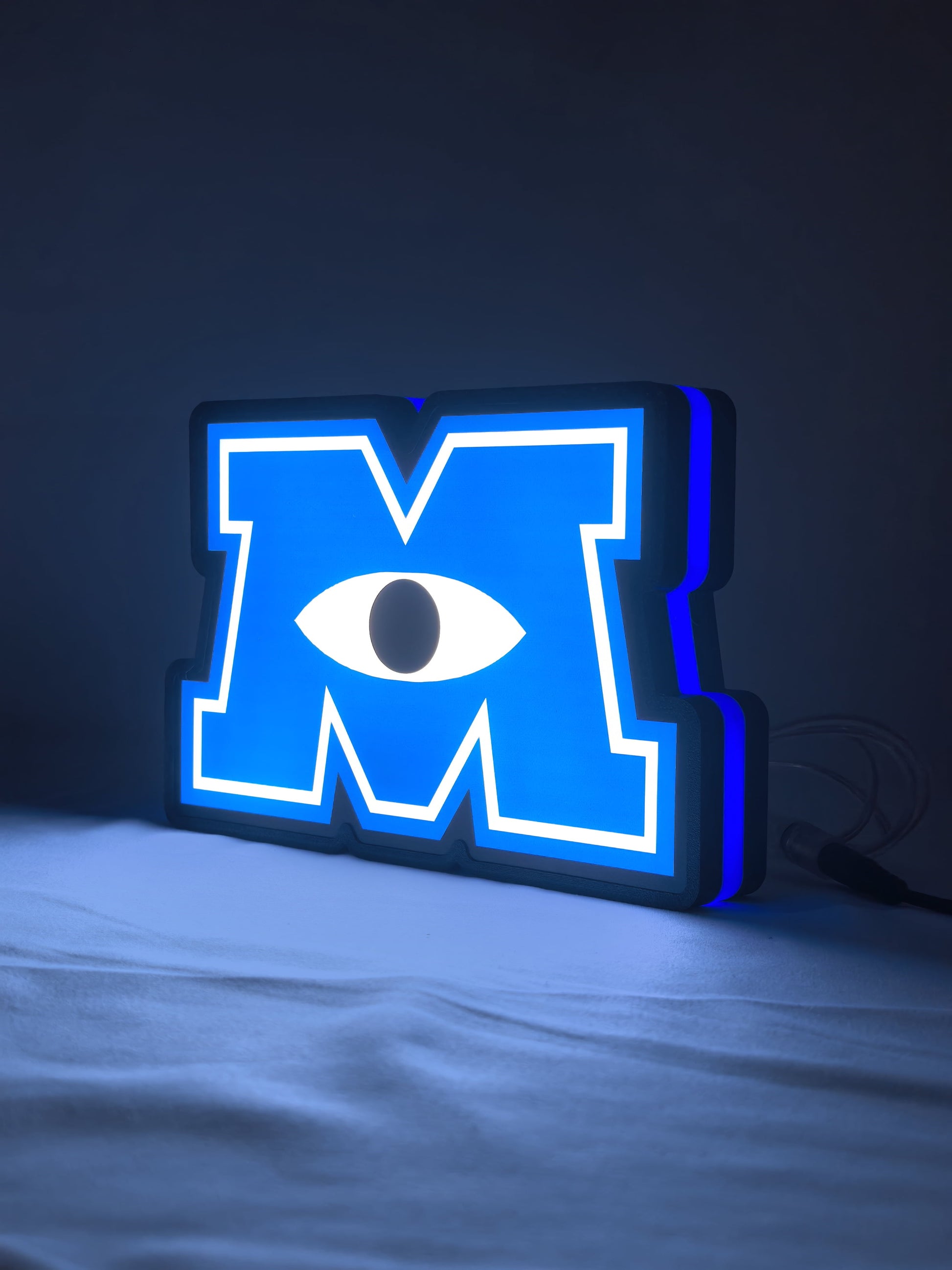 Illuminated angled view standing of Monsters University 3D LED Sign in 20cm, unique wall art for desk and room decor