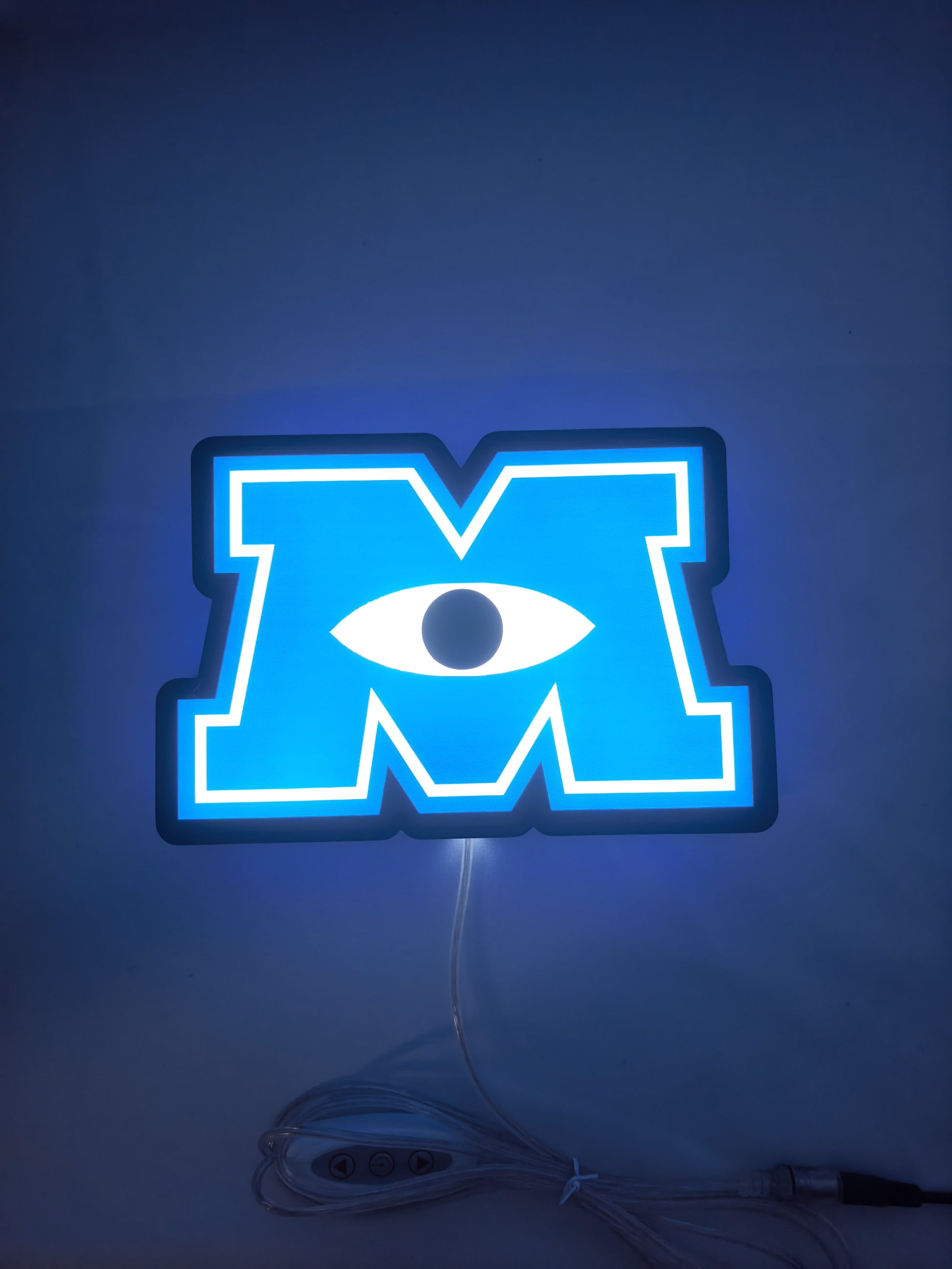 Illuminated flat lay front view of Monsters University 3D LED Sign in 20cm, unique wall art for desk and room decor