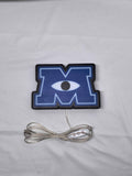 Unlit flat lay front details of Monsters University 3D LED Sign in 20cm, unique wall art for desk and room decor