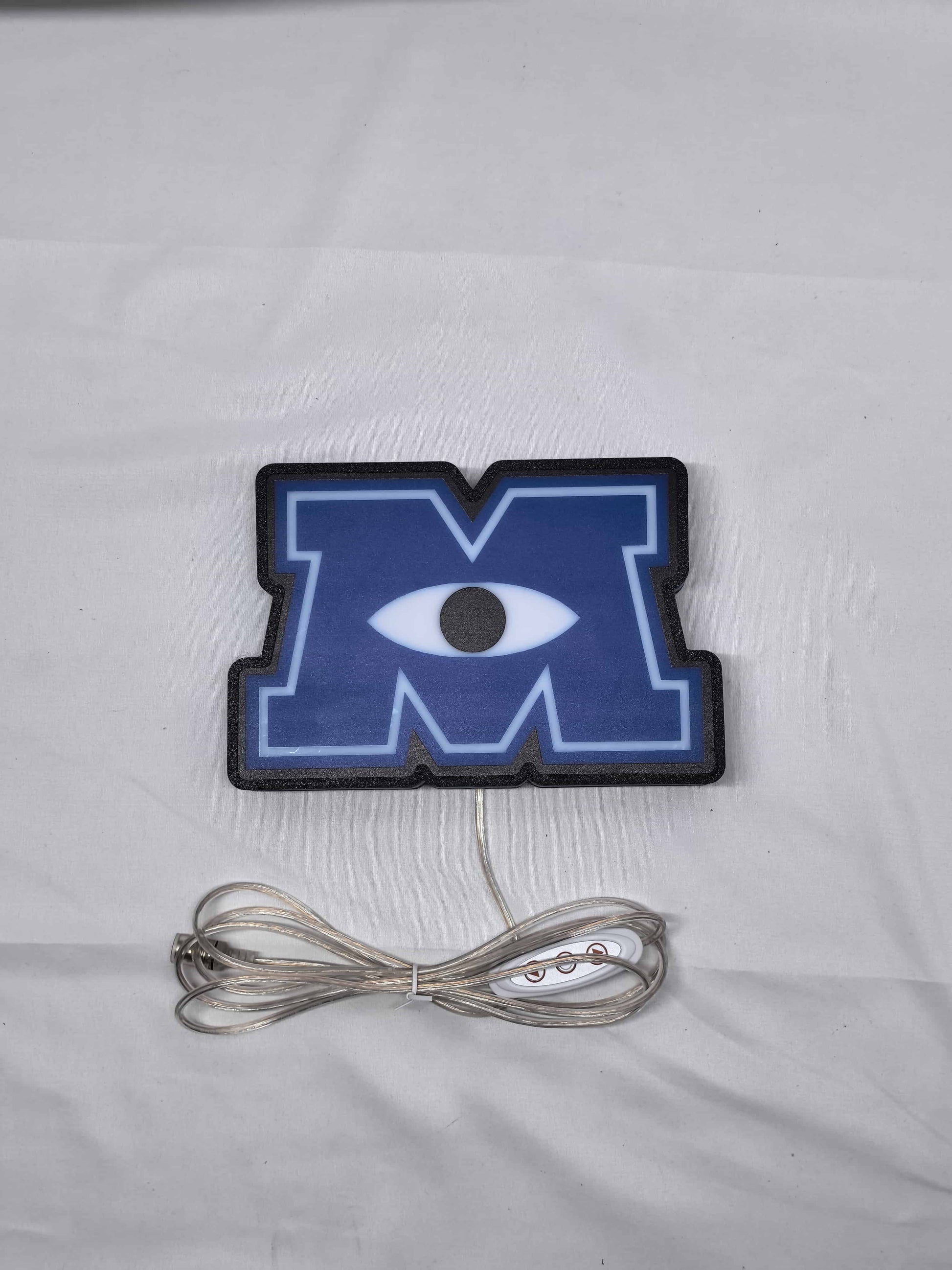 Unlit flat lay front details of Monsters University 3D LED Sign in 20cm, unique wall art for desk and room decor