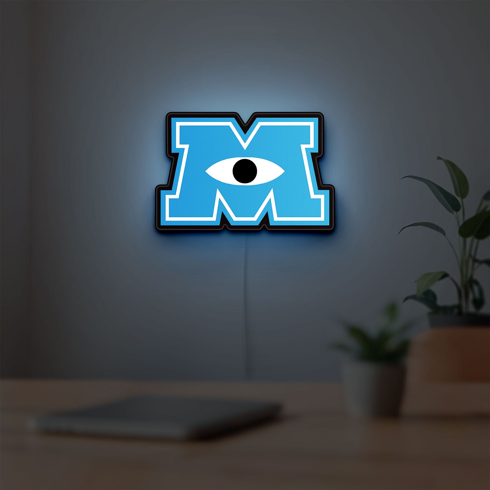 Monsters University LED lightbox hanging on a room wall with soft blue light
