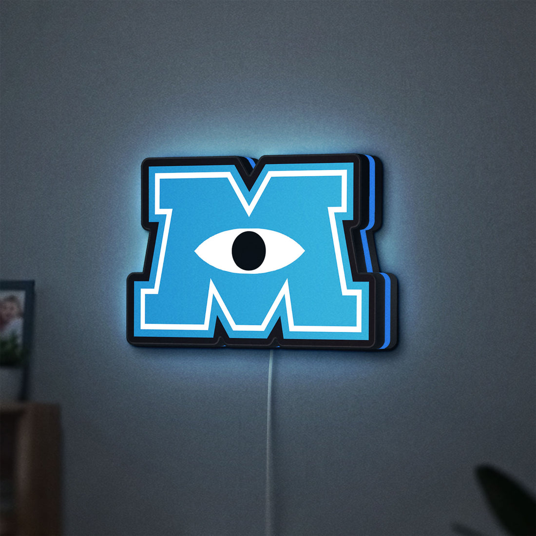 Monsters University LED lightbox hanging on a wall with blue glow
