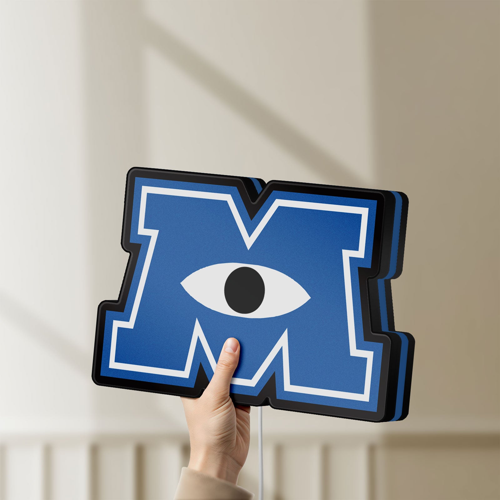 Unlit Monsters University LED lightbox held by hand to show size and details