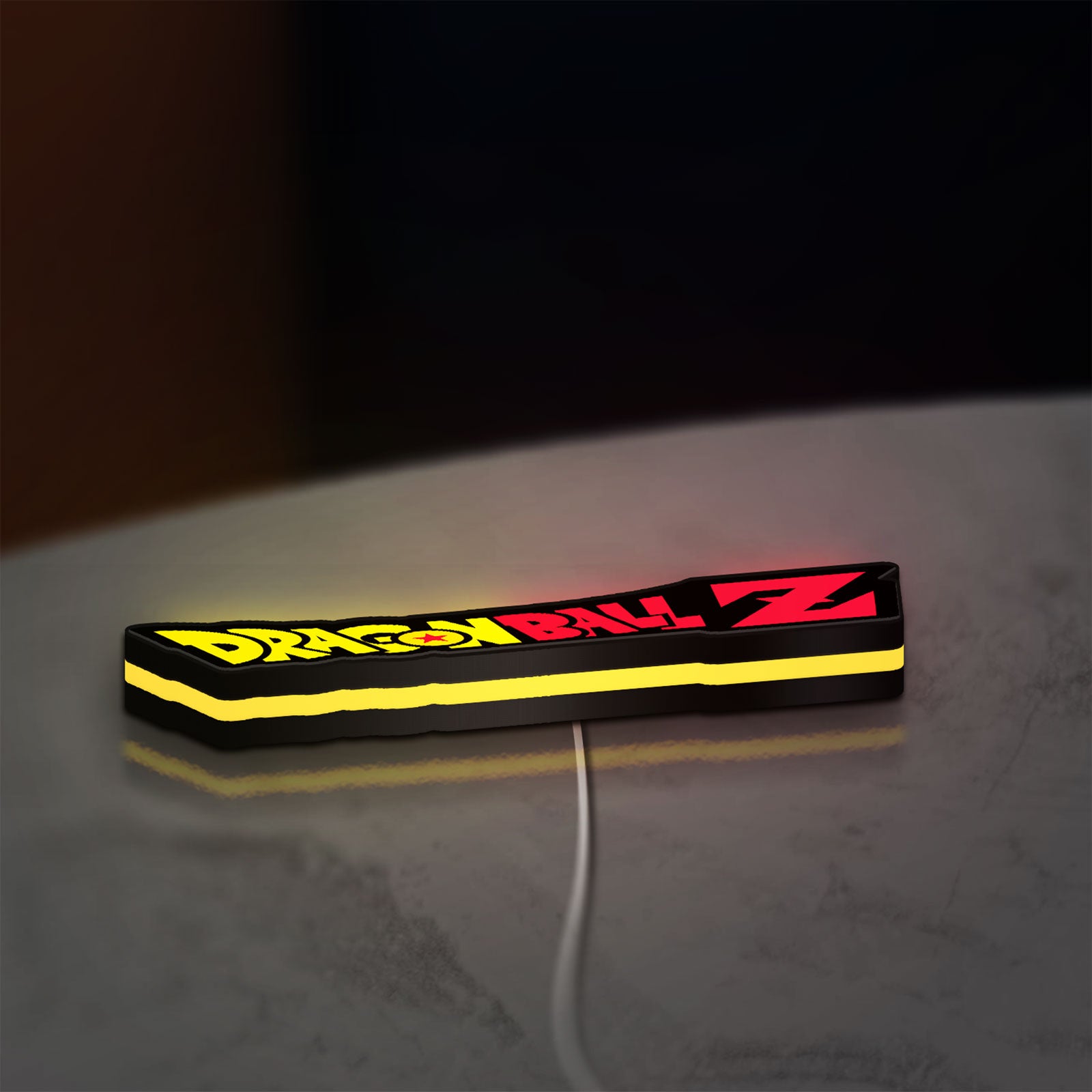 Dragon Ball Z LED lightbox lying flat on a desk with yellow glow