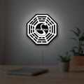 Dharma Initiative LED lightbox hanging on a room wall with soft white light