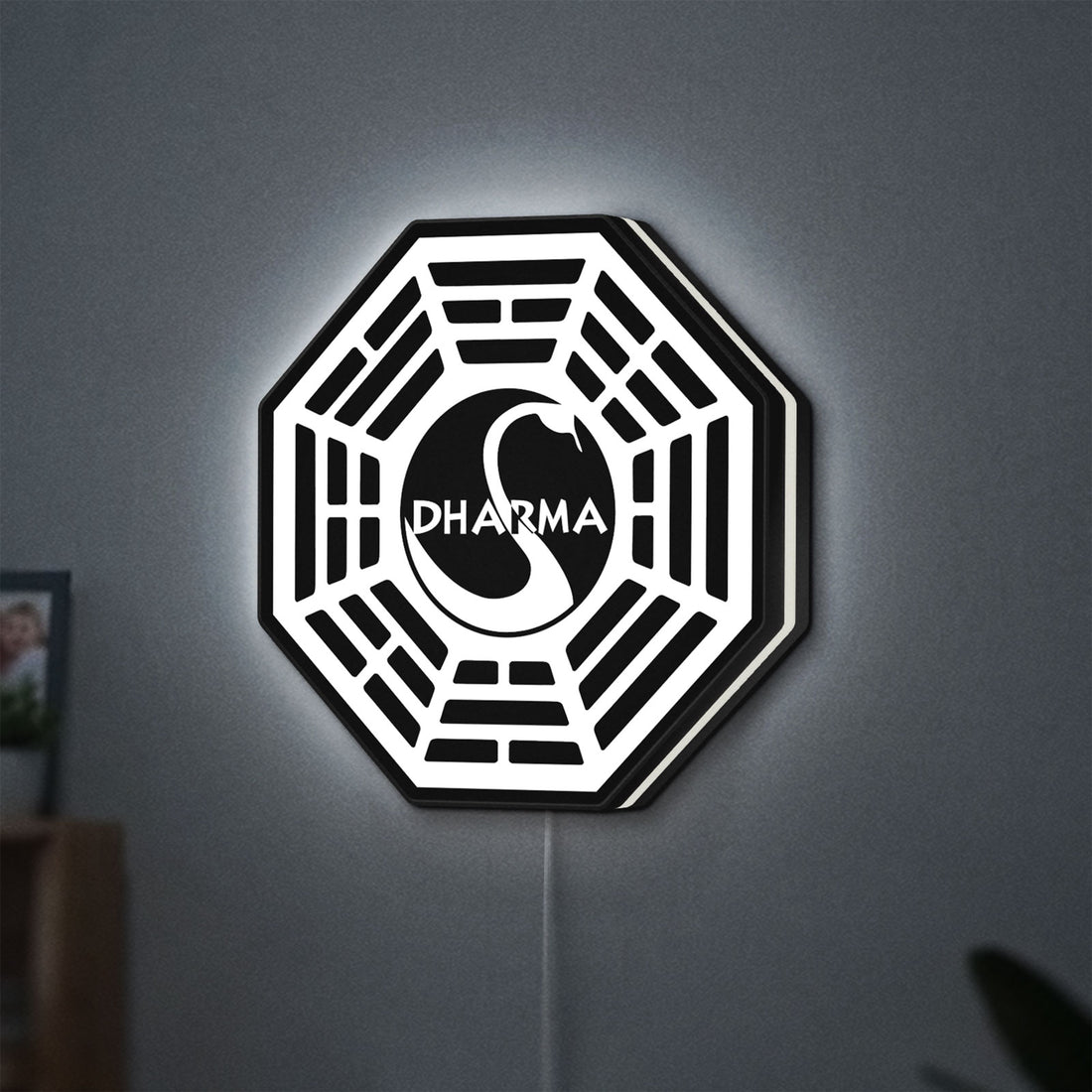 Dharma Initiative LED lightbox hanging on a wall with white glow