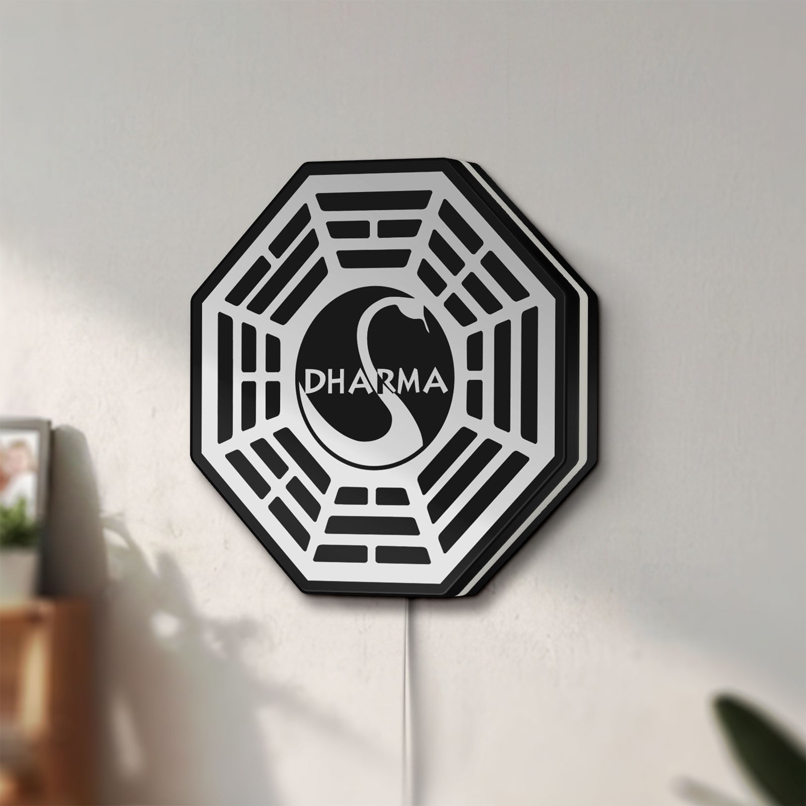 Unlit Dharma Initiative LED lightbox mounted on a wall in daylight