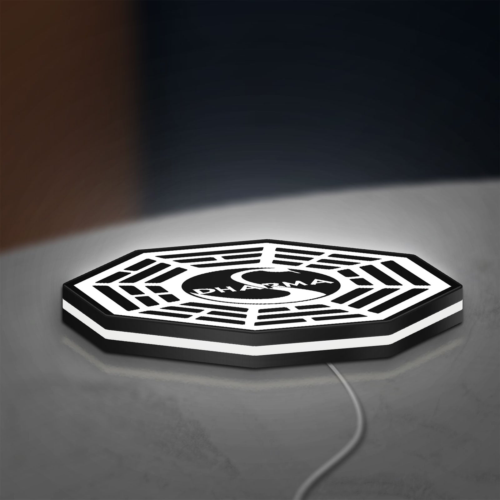 Dharma Initiative LED lightbox lying flat on a desk with white glow