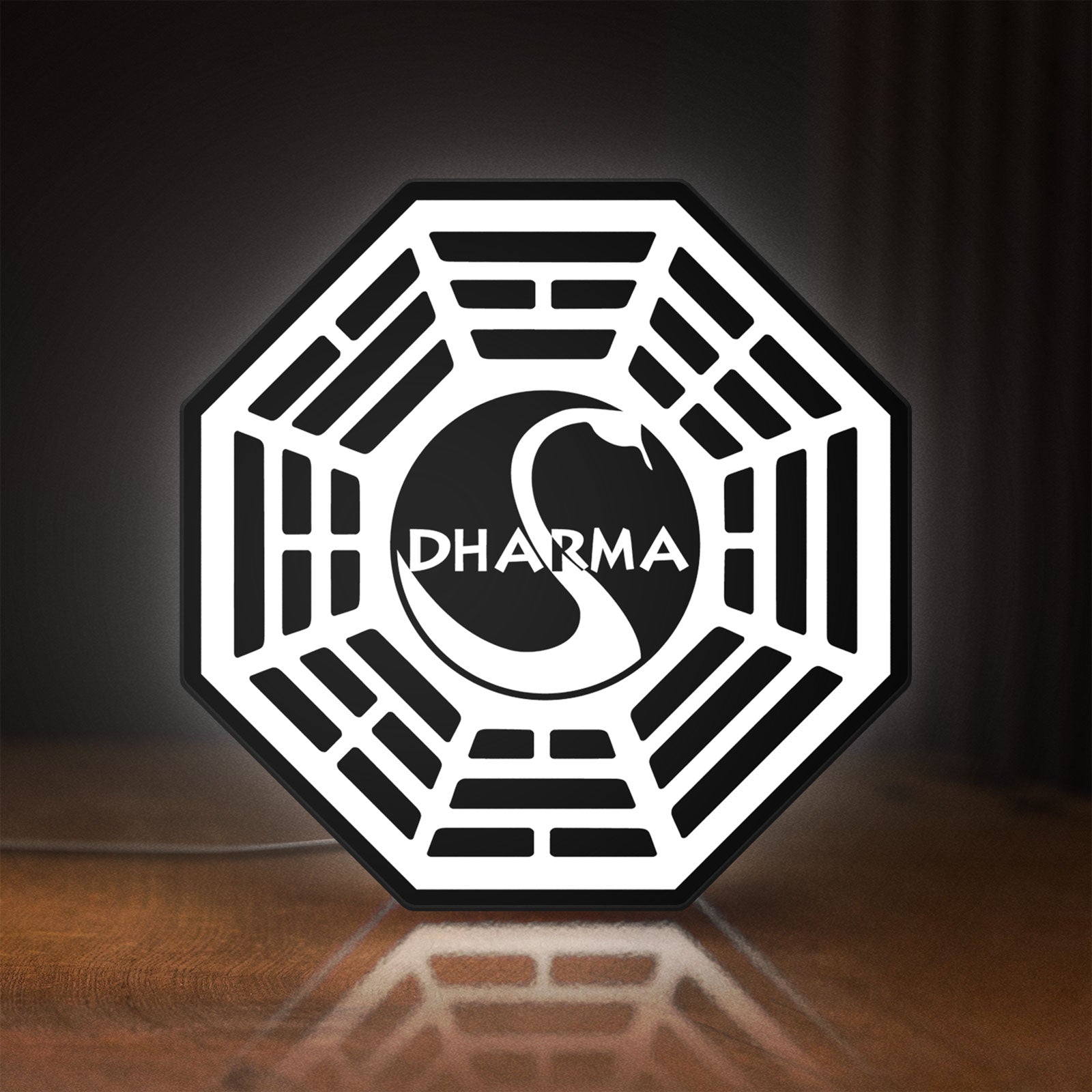 Front view of Dharma Initiative LED lightbox sign glowing on a wooden desk