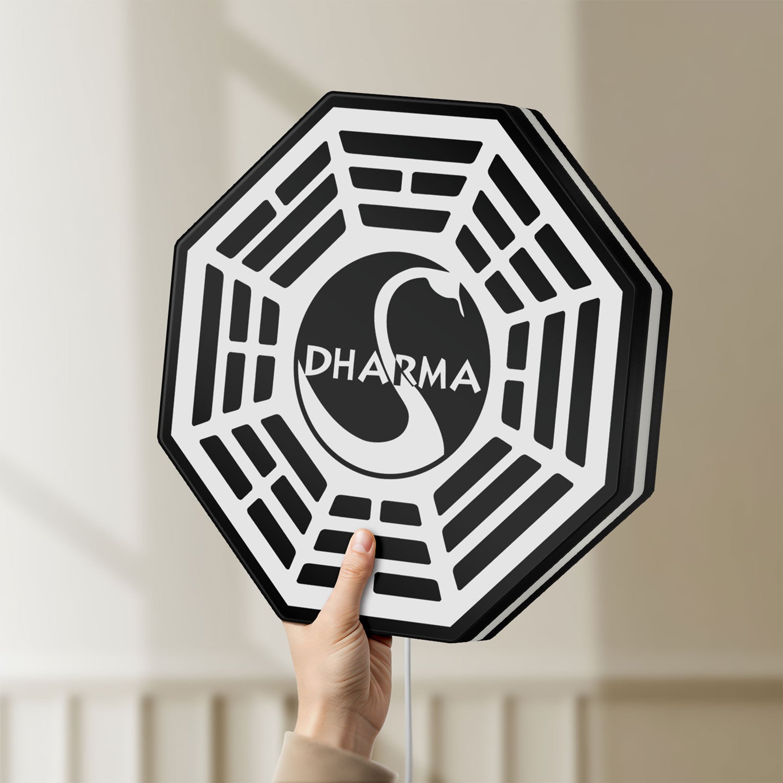 Unlit Dharma Initiative LED lightbox held by hand to show size and details