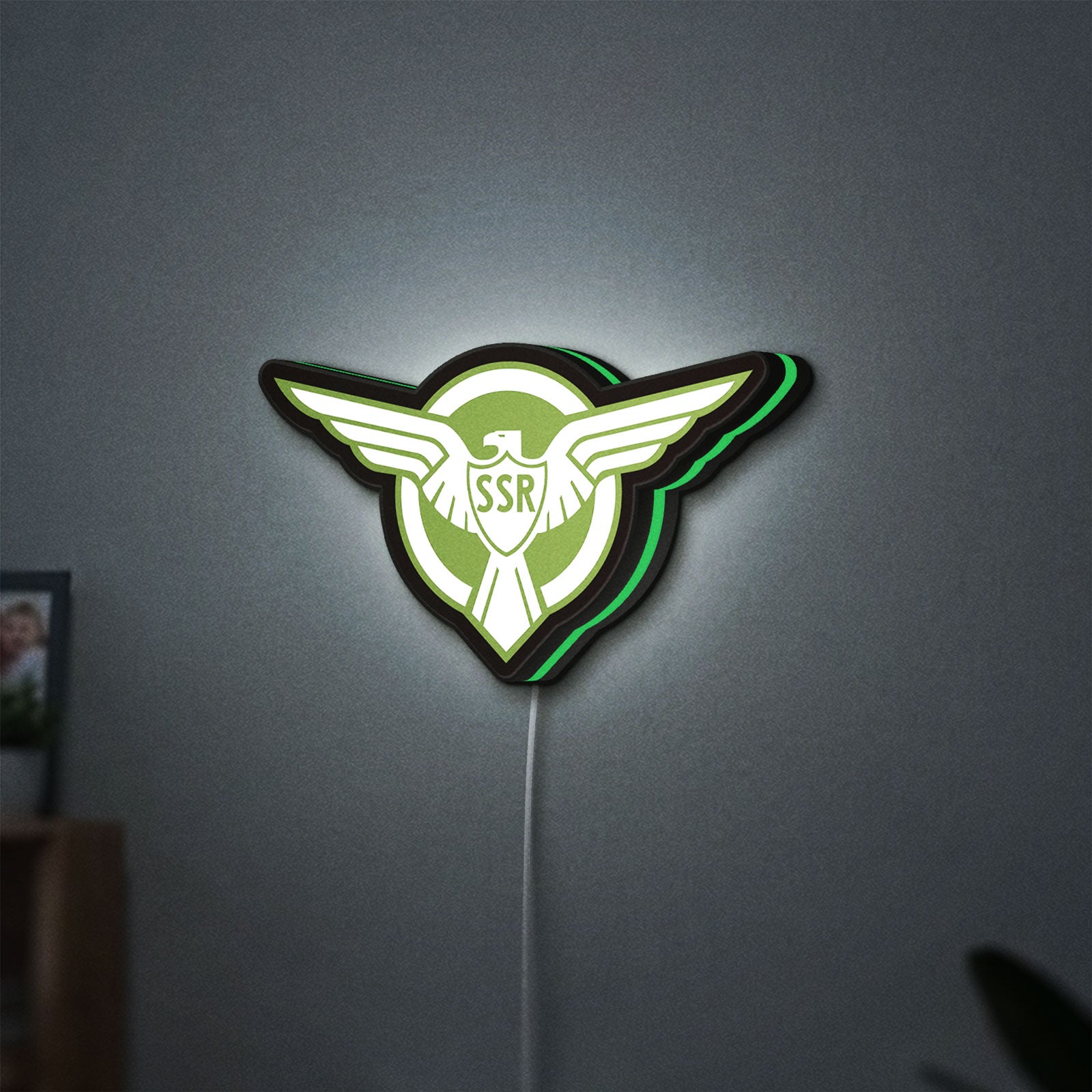 Captain America SSR LED lightbox hanging on a wall with green glow